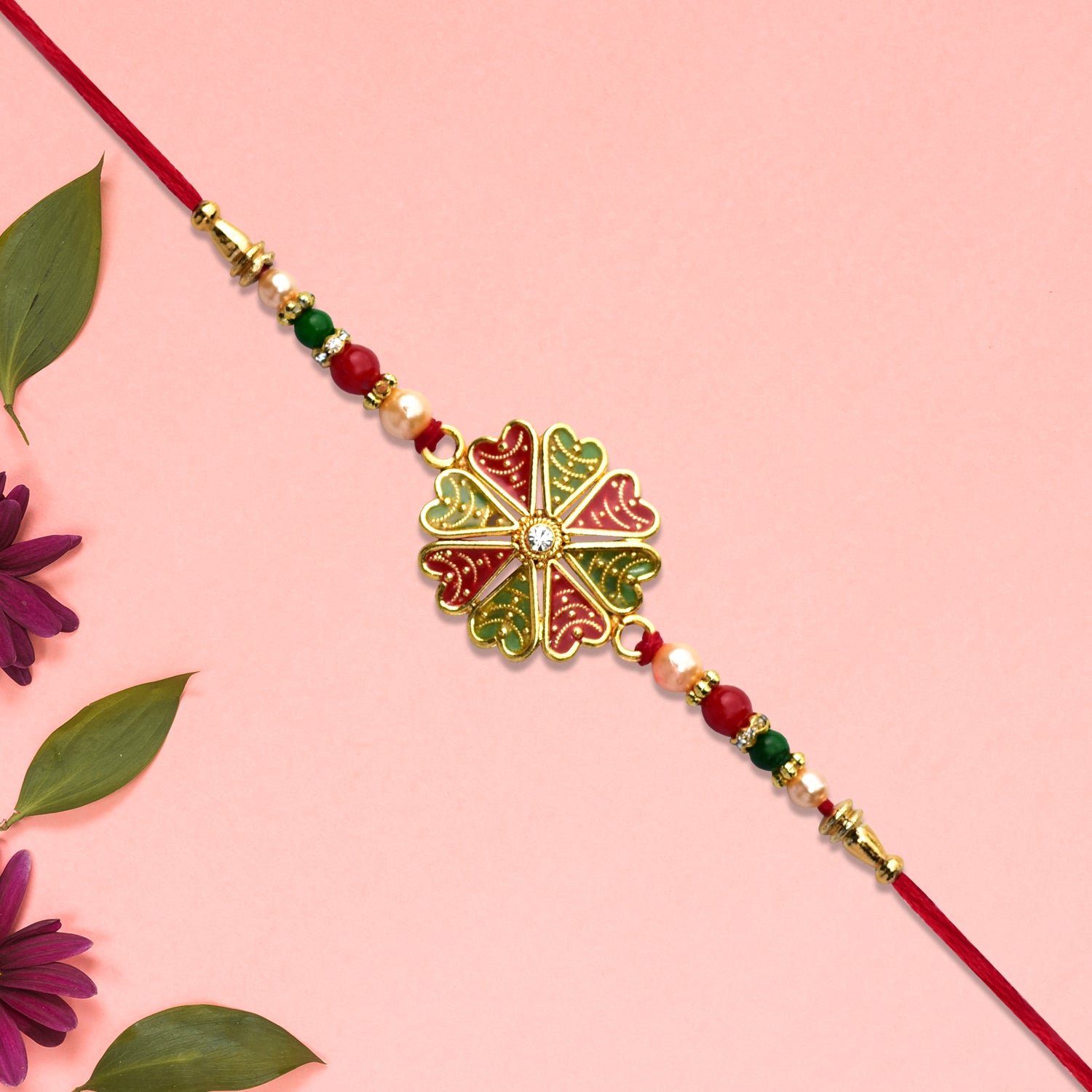 Traditional Rakhi With Bright Floral Centerpiece And Decorative Thread Traditional Rakhi With Bright Floral Centerpiece And Decorative Thread